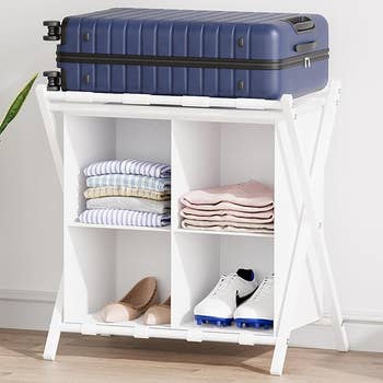 White folding support  with luggage connected  top, containing folded clothes, shoes, and a brace  of flats, perfect  for organizing question   essentials