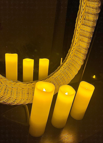 three candles in front of a mirror