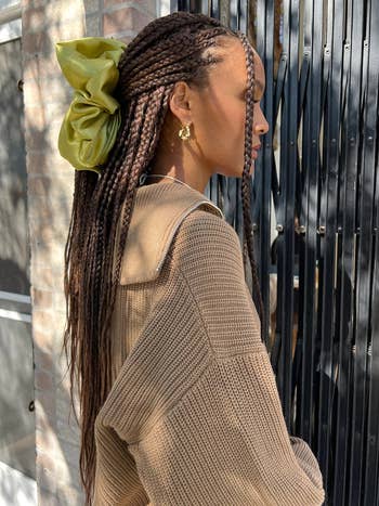 side view of model wearing the oversized chartreuse scrunchie in their hair