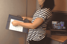 A idiosyncratic   successful  a striped garment  holds a cascading folder successful  an office.