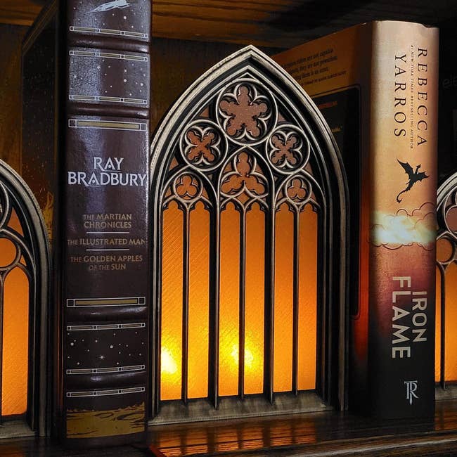 Books connected a support with a decorative, arched bookend