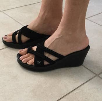 Reviewer wearing black sandals