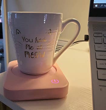 reviewer photo of a mug on the pink mug warmer