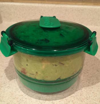 a reviewer photo of the container filled with guac 