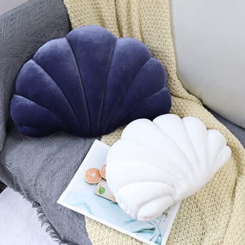 the purple version and white version of the seashell pillow