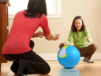 two models rolling the ice cream ball back and forth to each other