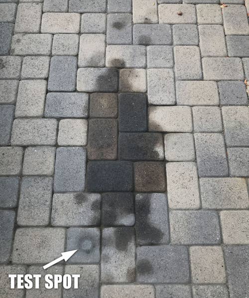 large oil stain in a reviewer's stone driveway, with one part labeled 