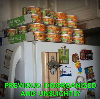 reviewer pic of wet cat food tins stacked on top of fridge