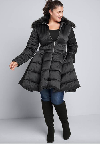 image of model wearing black peplum puffer coat