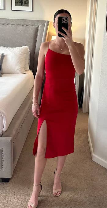 reviewer in the spaghetti strap red midi dress