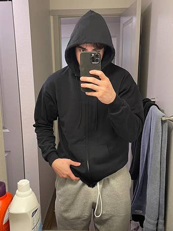reviewer wearing a black hoodie