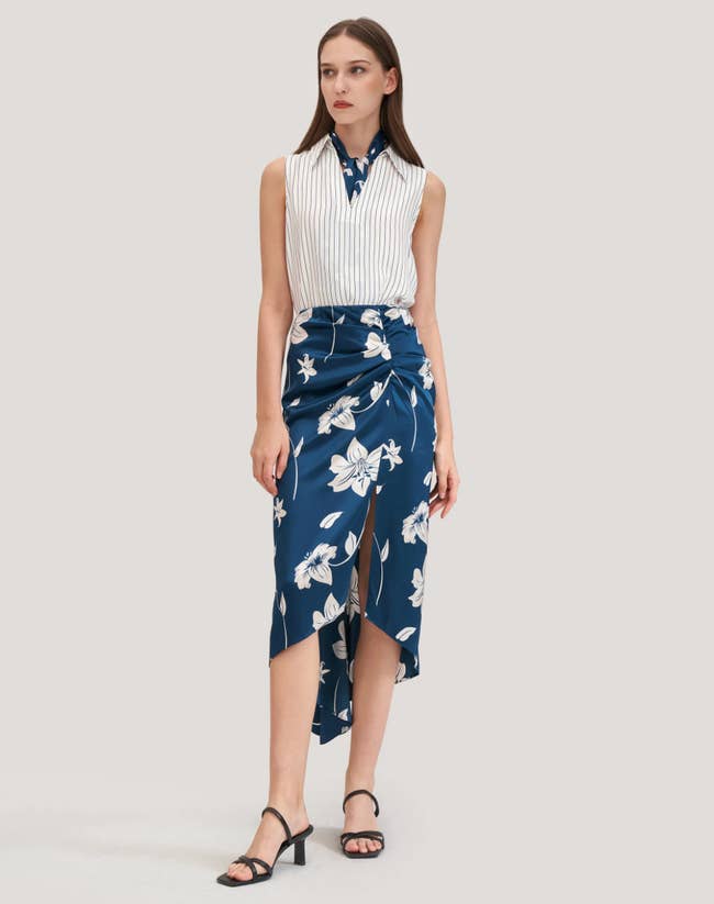 model wearing the silk skirt in blue with white lilys all over it