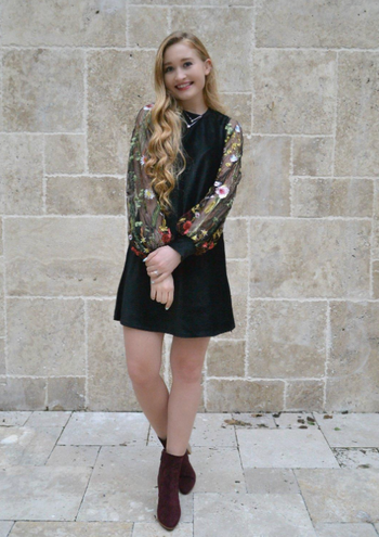 reviewer wearing dress with boots