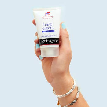 models hand holds the cream