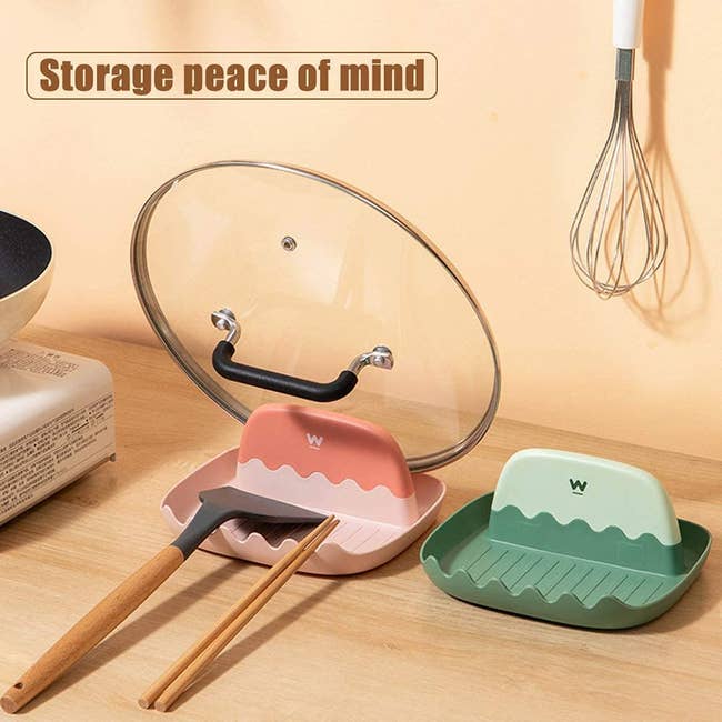 a spatular chopsticks and a pan lid resting on the multipurpose holder