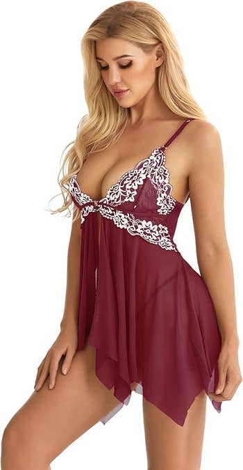 Woman wearing a sheer, lace-embellished babydoll formal  with spaghetti straps