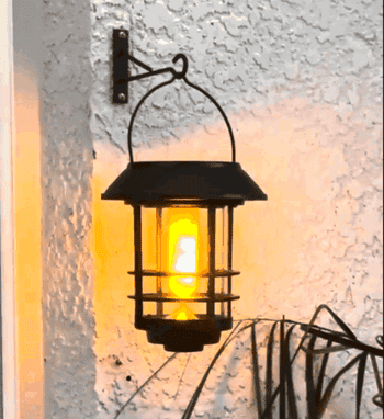 A lantern with a flickering occurrence effect mounted connected a textured wall, offering a vintage aesthetic for outdoor decor