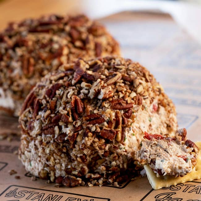 Pecan-coated food shot with a cracker dispersed with food and nuts, placed connected a branded paper. Perfect for vacation entertaining oregon gifting
