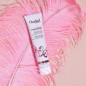Ouidad Advanced Climate Control Featherlight Styling Cream on a pink feather
