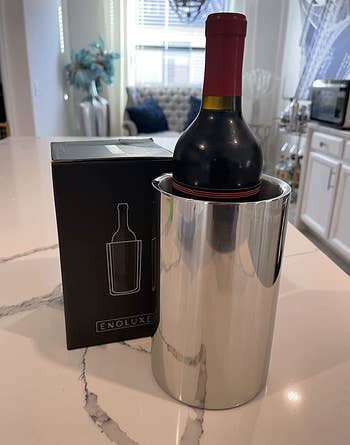 reviewer photo of the silver chilling bucket holding a bottle of wine on a kitchen counter