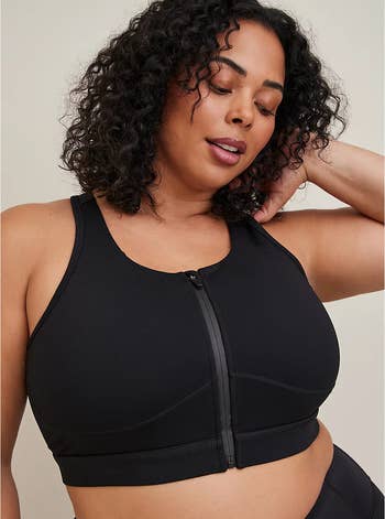 model wearing the zip-up black sports bra