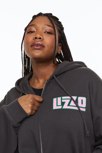 model showing the front of the hoodie with the name 