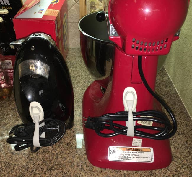 a reviewer photo of the cord bundlers attached with an iron and a stand mixer 