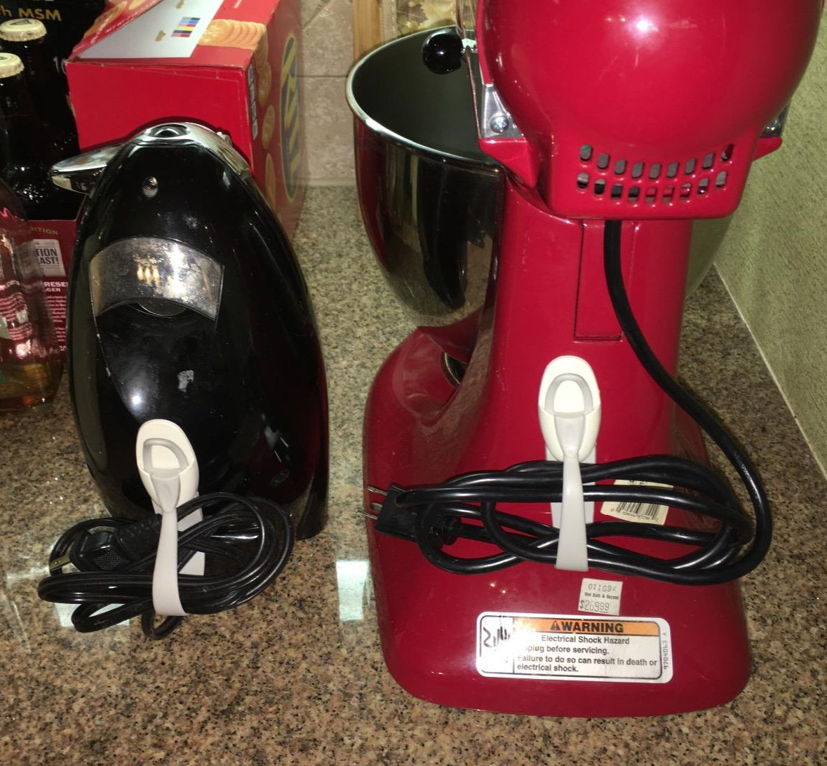 a reviewer photo of the cord bundlers attached with an iron and a stand mixer