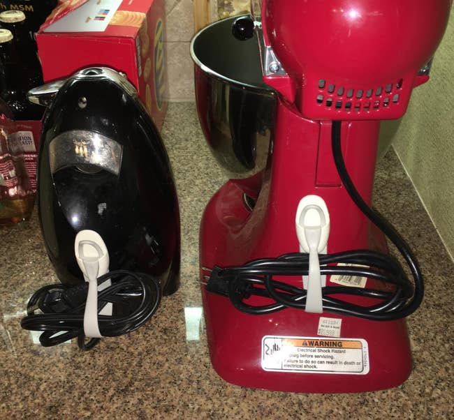 a reviewer photo of the cord bundlers attached with an iron and a stand mixer 