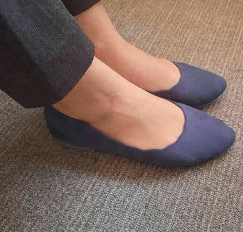 reviewer wearing the blue flats