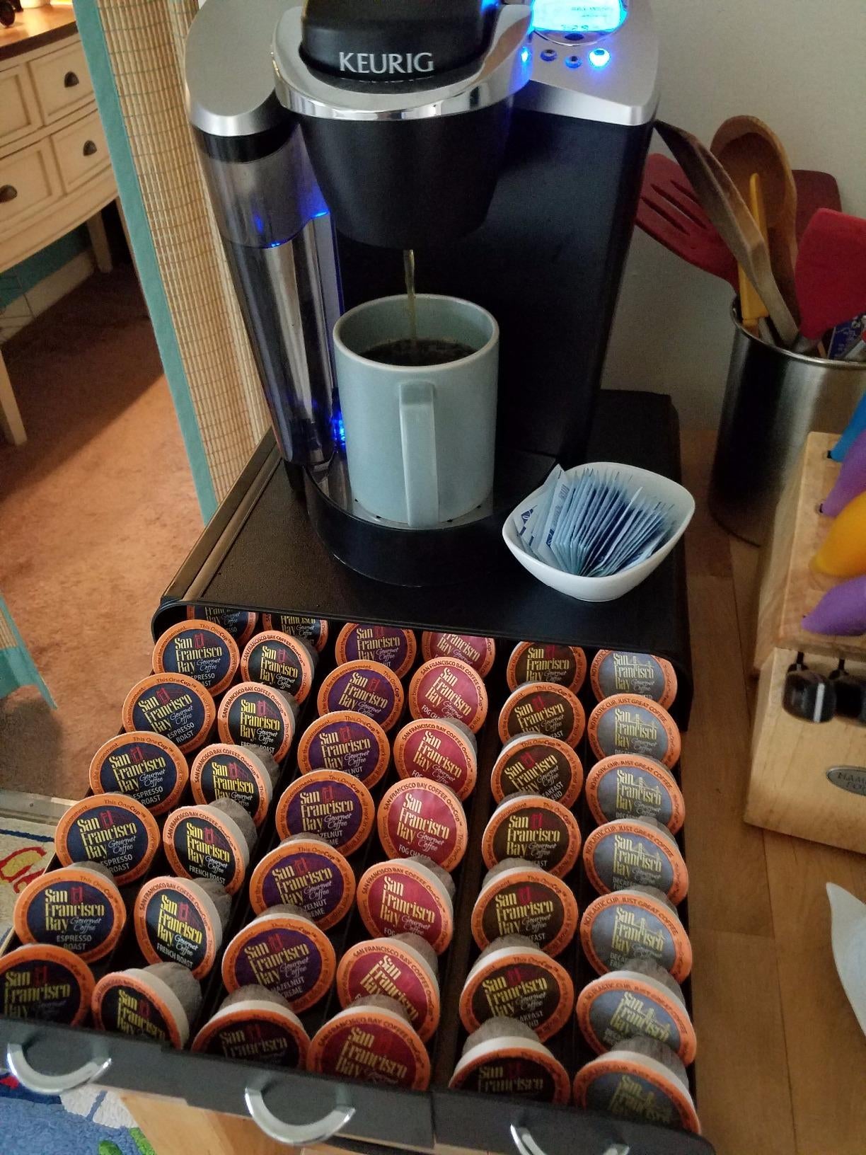 black drawer underneath a keurig holding various k-cups