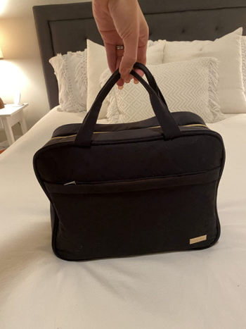 hotel the bag closed up and propped up on bed