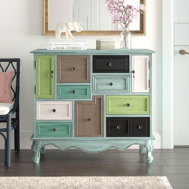 the colorful cabinet with four different colors on the drawers