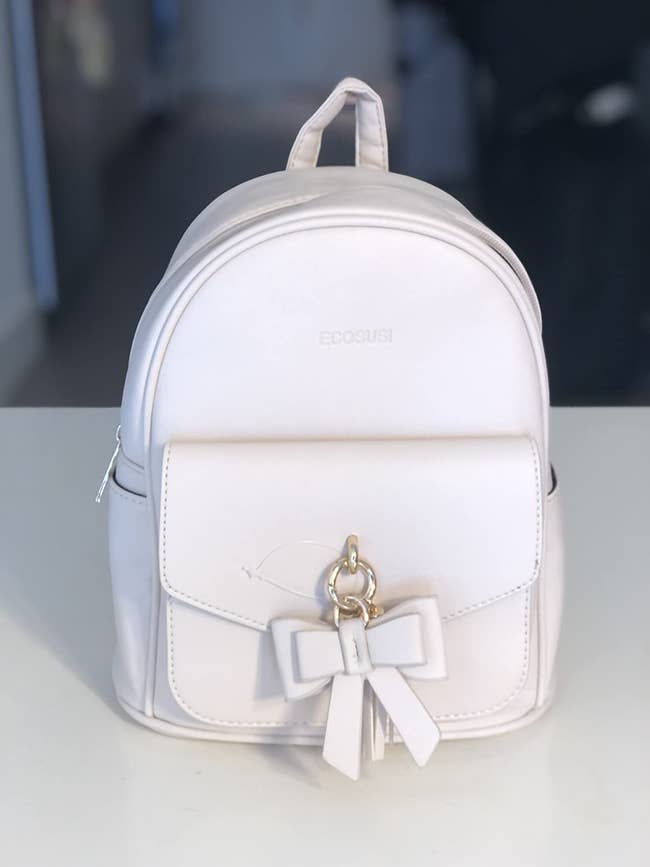 reviewer photo of white bow knot mini backpack