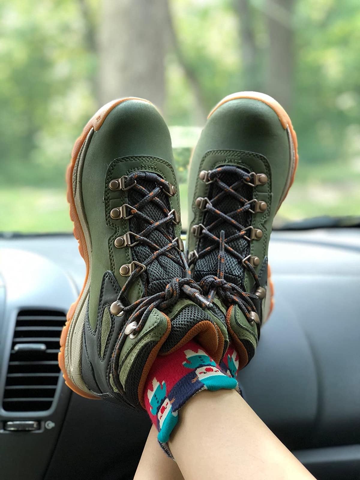 close up of the green and caramel hiking boots on a reviewer's feet