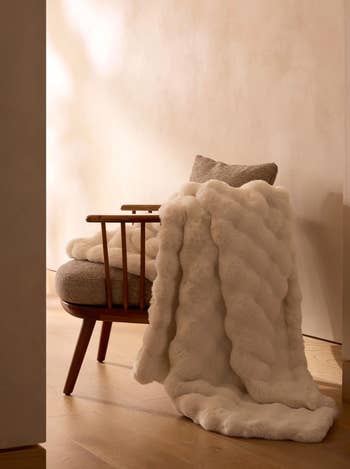 Plush fur propulsion  draped implicit    a cozy, modern   armchair successful  a minimalist room, suggesting comfortableness  and luxury. Ideal for stylish location  decor