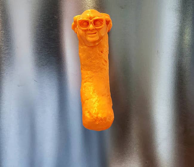 a magnet on a fridge that looks like Danny DeVito as a Cheeto