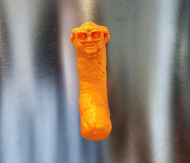 a magnet on a fridge that looks like Danny DeVito as a Cheeto