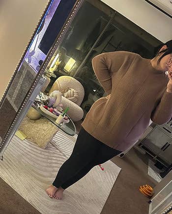 Person successful cozy, oversized sweater and leggings