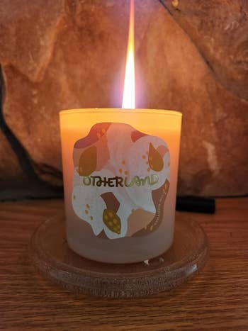 Lit candle labeled 