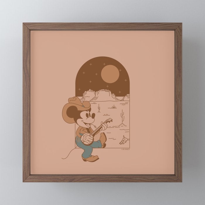a small framed square print of cowboy mickey playing the banjo
