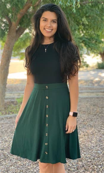 Image of reviewer wearing black and green dress
