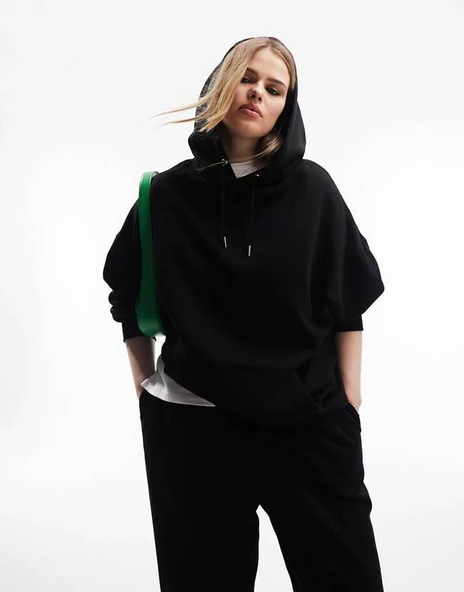 model wearing black oversized hoodie