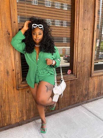 reviewer wearing the long-sleeved blouse and drawstring shorts set in dark green