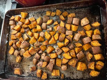 Roasted saccharine  murphy  cubes connected  a baking sheet, seasoned with herbs and spices, perfect  for a steadfast   repast  oregon  broadside  dish