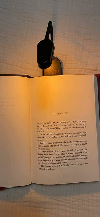 a clip on amber light used to read a book at night
