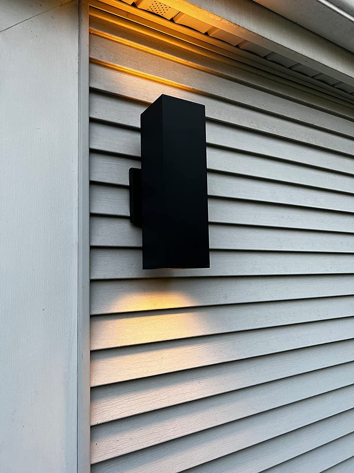 reviewer's black sconce mounted on the outer wall of a house