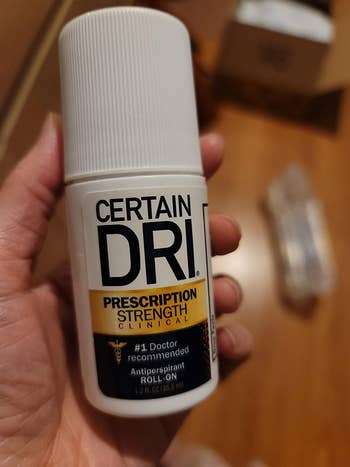 reviewer holding up certain dri deodorant