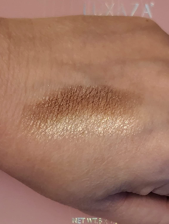 a reviewer swatching one of the shimmers