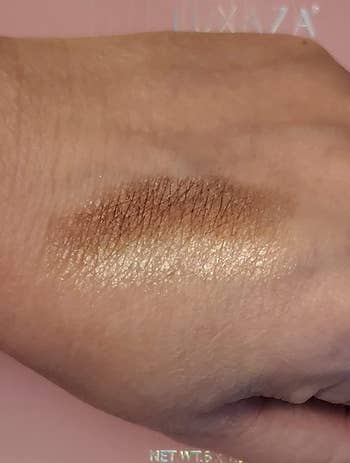 a reviewer swatching one of the shimmers